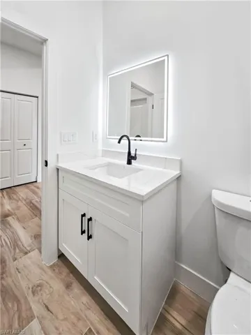 Bathroom featuring light wood-style flooring and vanity