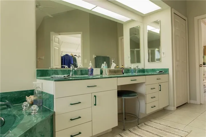 Bathroom with vanity, tile patterned flooring, and ceiling fan