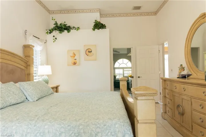 Tiled bedroom with a towering ceiling