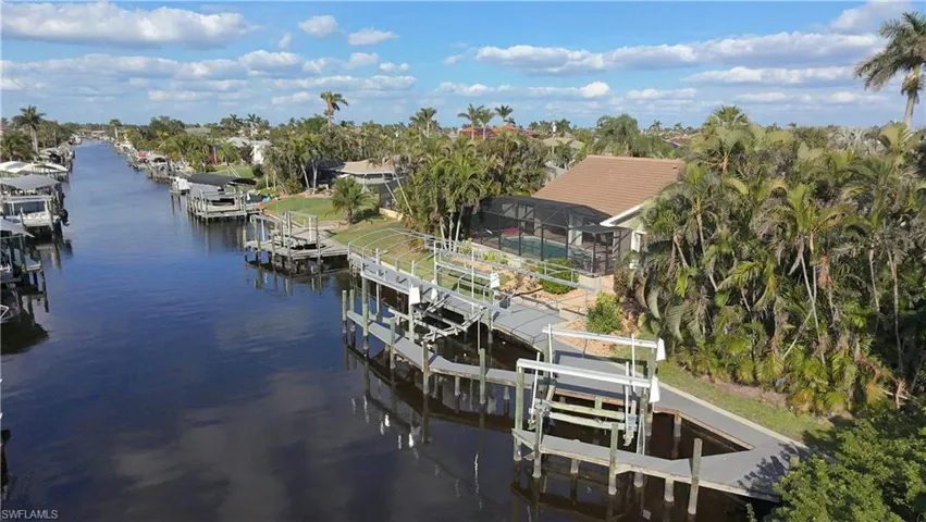 Dock area with a water view and glass enclosure