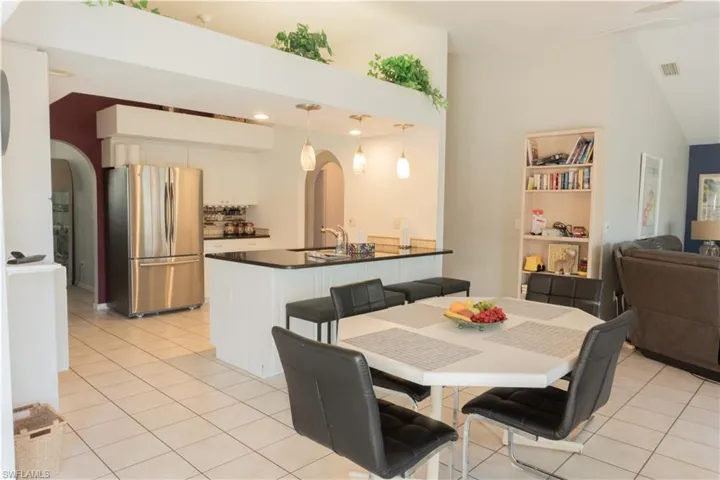Tiled dining space featuring sink