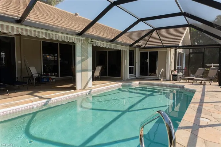 View of swimming pool with a lanai and a patio area