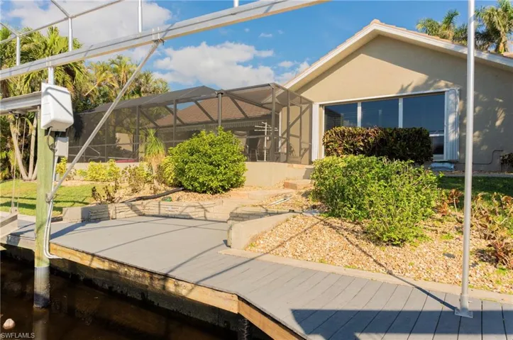 Back of property with glass enclosure