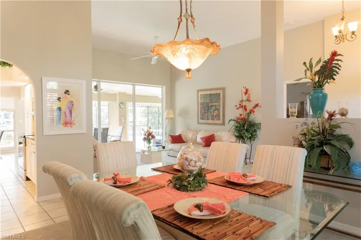 Tiled dining space featuring an inviting chandelier