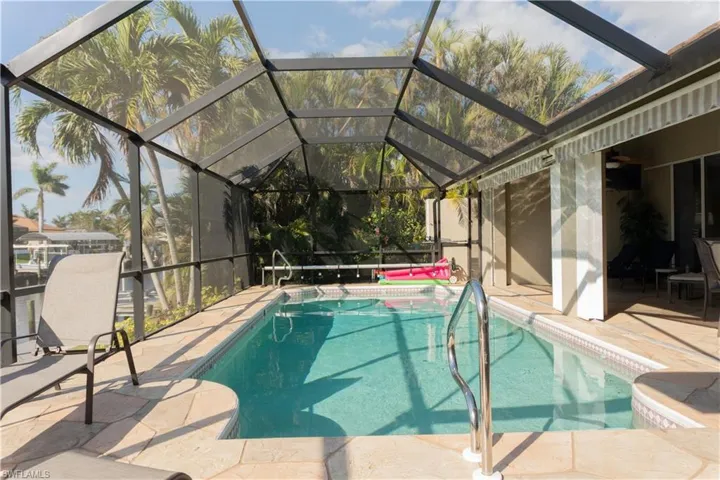 View of swimming pool with a lanai and a patio area