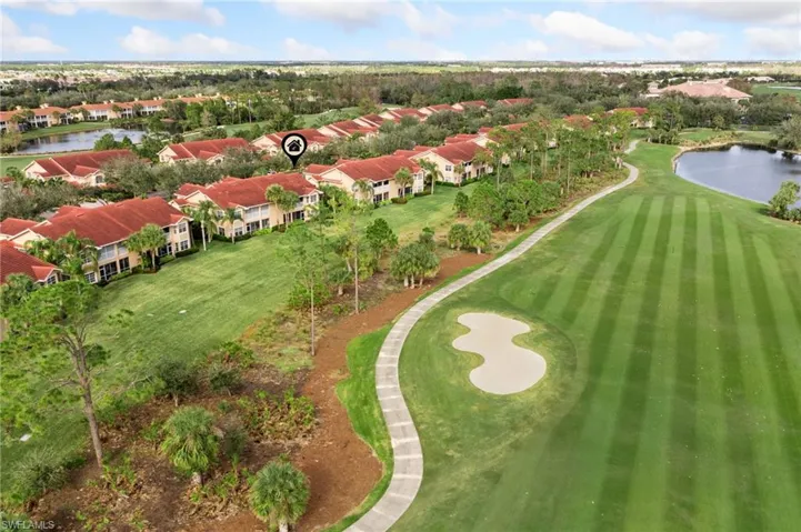 Birds eye view of property with a water view
