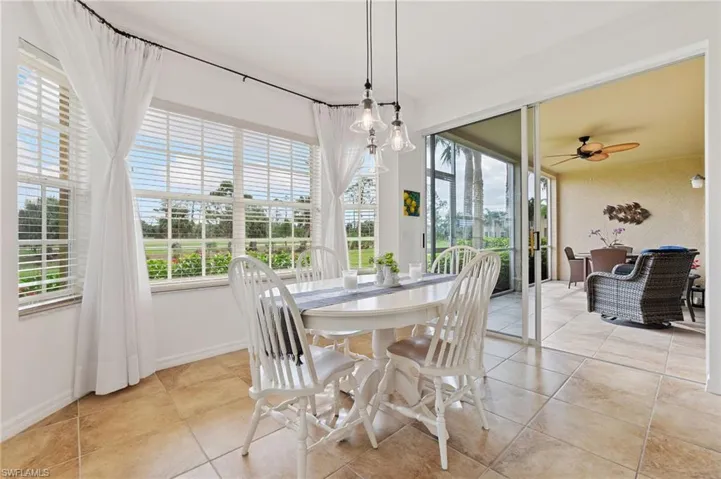 Dining area with a wealth of natural light, ceiling fan, and light tile patterned floors