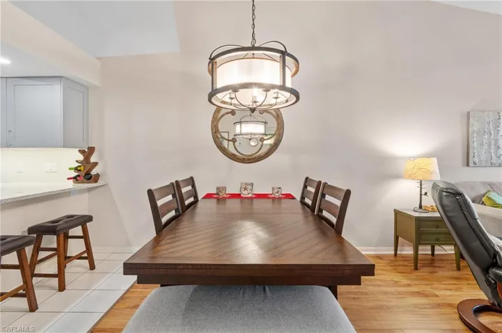 Dining space with a chandelier and light wood-type flooring