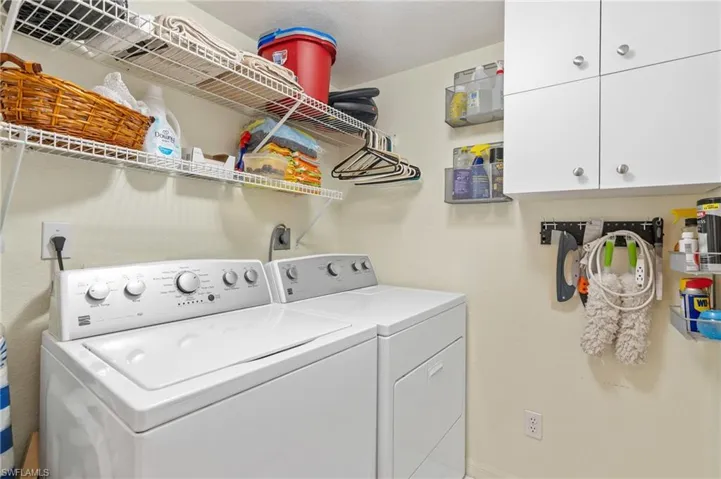 Clothes washing area with separate washer and dryer and cabinets
