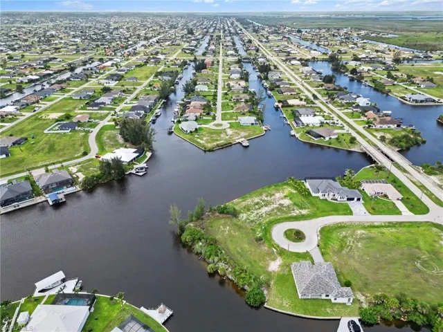 Aerial perspective showcasing a residential area featuring numerous waterfront properties with direct canal access