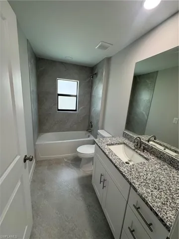 Bathroom with vanity and shower / bath combination