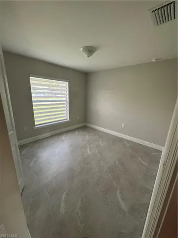 Unfurnished room featuring baseboards