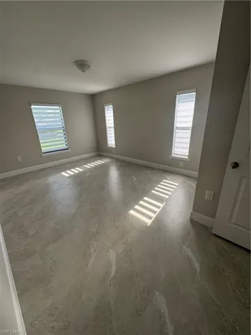 Spare room featuring baseboards