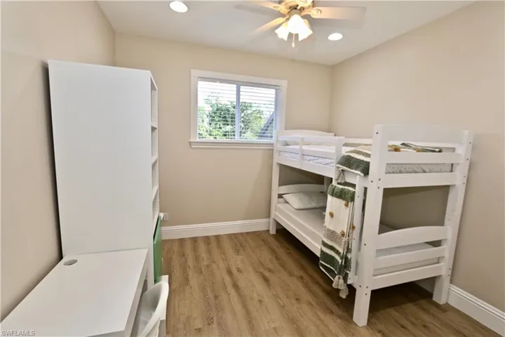 Bedroom with light wood-style flooring, a ceiling fan, and recessed lighting