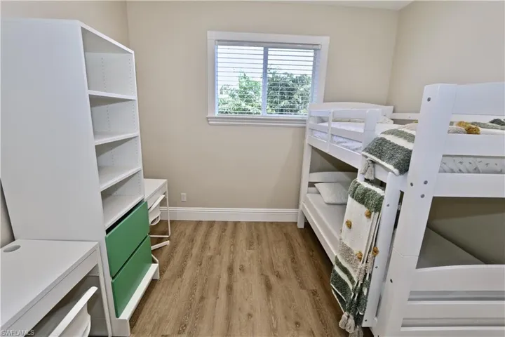 Bedroom featuring baseboards and light wood-type flooring