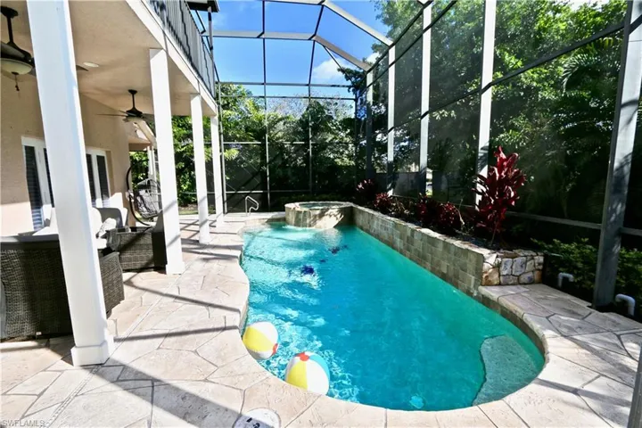 Combined pool / hot tub with a patio area, a lanai, and a sunroom