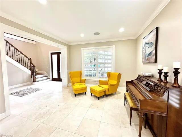Living area featuring ornamental molding, recessed lighting, and french doors