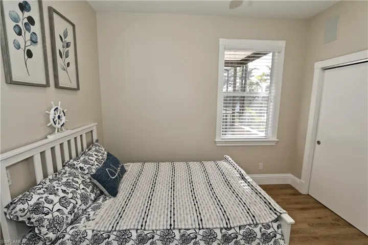 Bedroom featuring wood finished floors, a closet, and ceiling fan