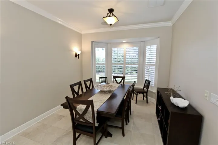 Dining room with baseboards and ornamental molding