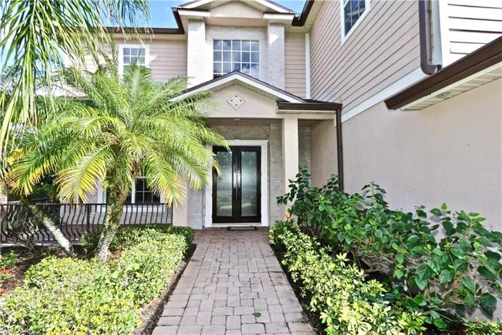 View of exterior entry featuring french doors and stucco siding