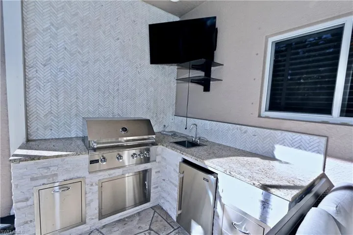 View of patio / terrace featuring exterior kitchen and a sink