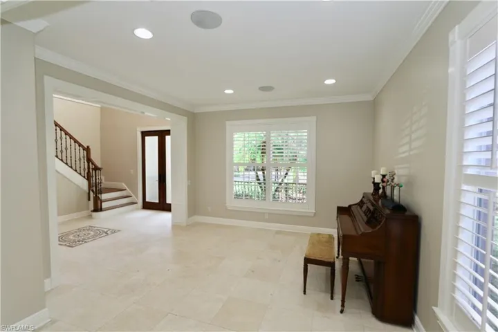 Foyer featuring crown molding, french doors, and recessed lighting
