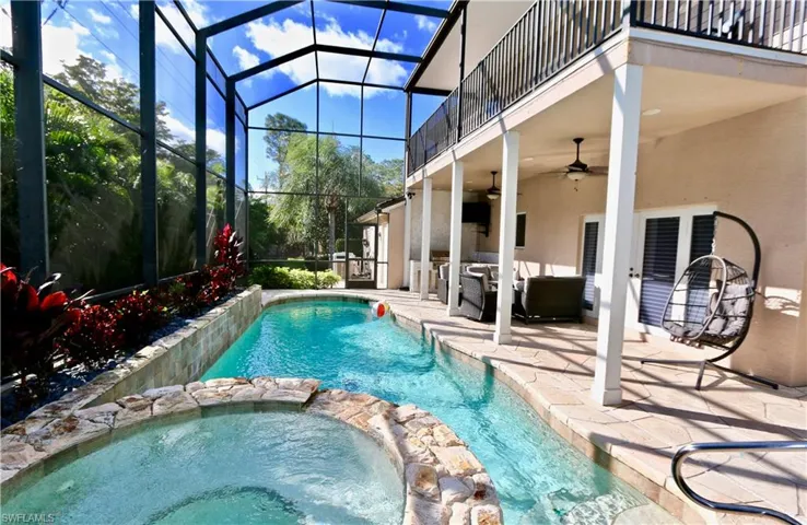 Integrated pool / spa featuring a sunroom, a patio area, glass enclosure, and an outdoor living space
