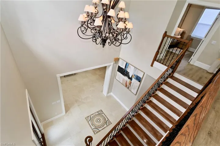 Stairway with hanging lights and a high ceiling