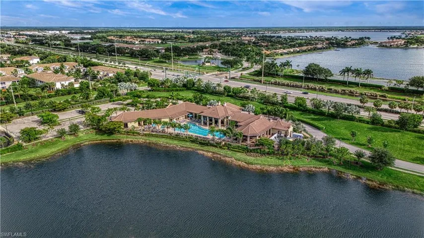 Birds eye view of property with a water view