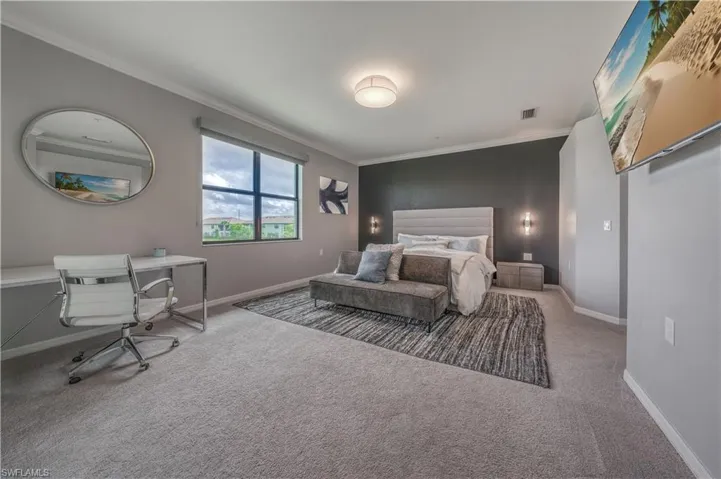 Bedroom featuring ornamental molding and carpet flooring