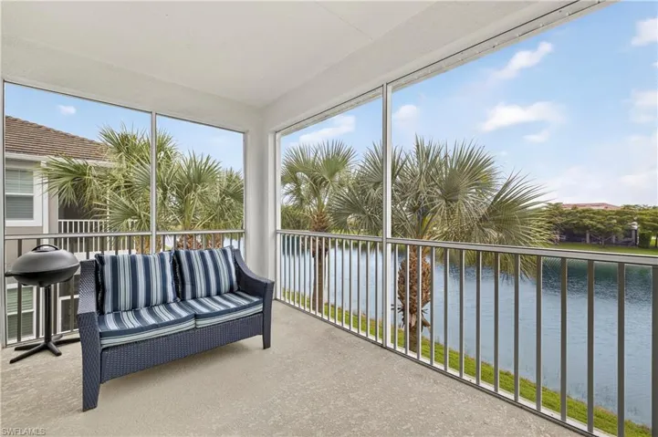 Sunroom / solarium with a water view and carpet floors