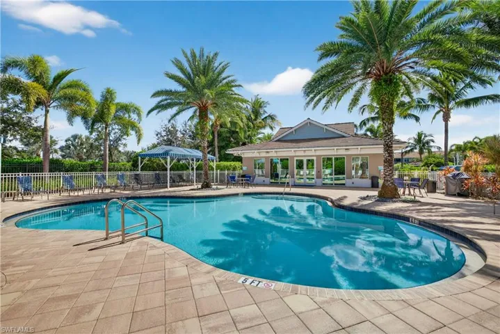 Community pool with a patio area and grilling area