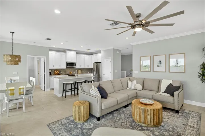 Living room featuring ornamental molding, recessed lighting, a ceiling fan, and light tile patterned floors