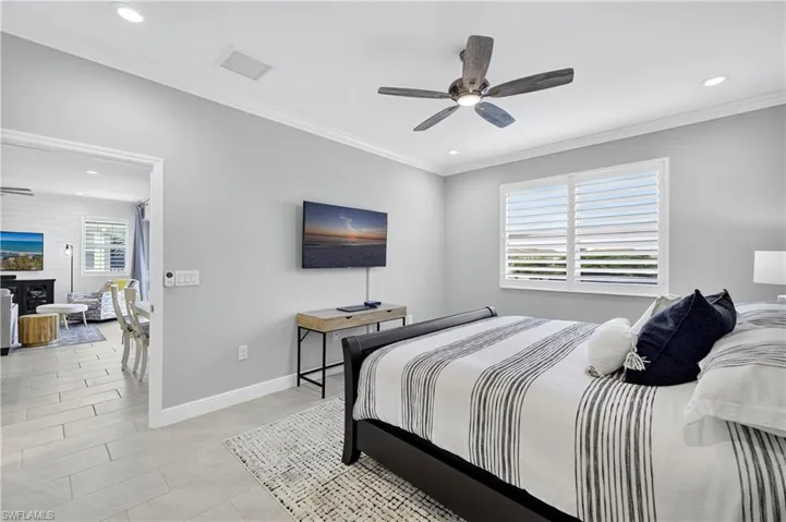 Bedroom with ornamental molding, recessed lighting, ceiling fan, and light tile patterned flooring