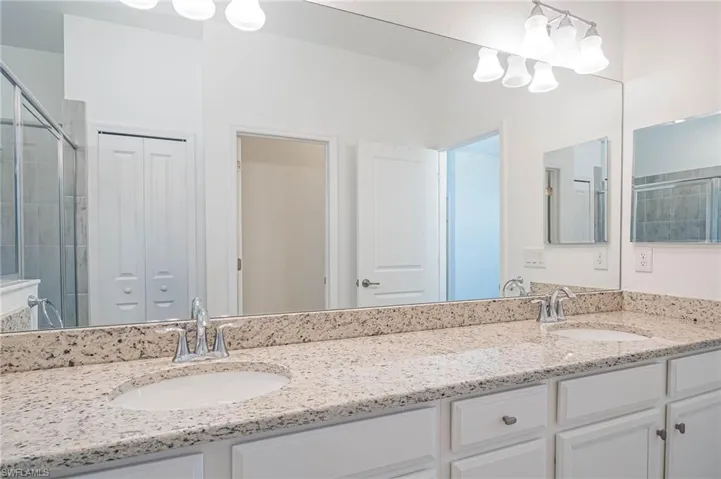Bathroom featuring vanity and an enclosed shower