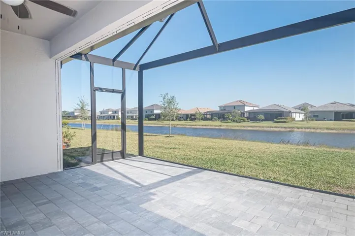 Unfurnished sunroom featuring ceiling fan and a water view