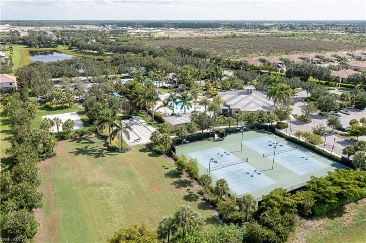 Birds eye view of property with a water view