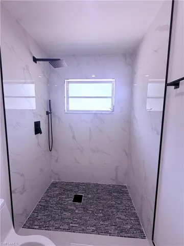 Full bath with a stall shower and toilet
