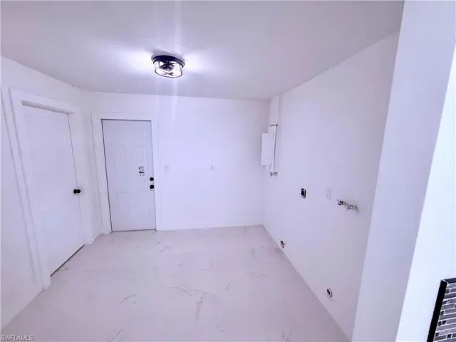Clothes washing area with marble finish floor