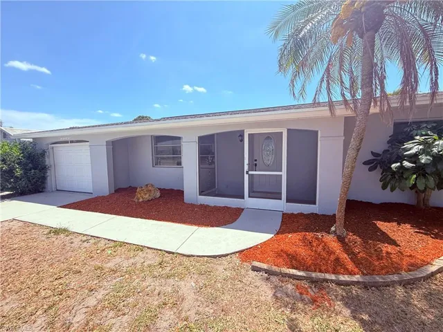 Single story home featuring stucco siding and a garage