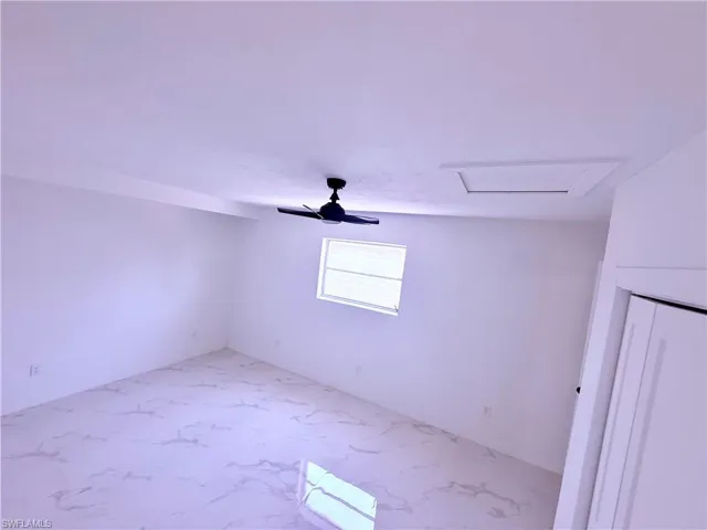 Spare room featuring marble finish floor