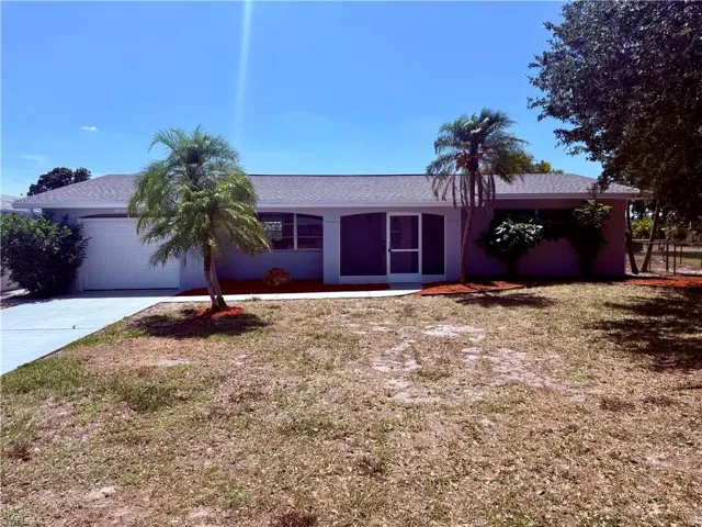 Ranch-style house with an attached garage and concrete driveway
