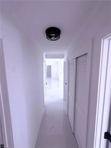 Hallway featuring ornamental molding