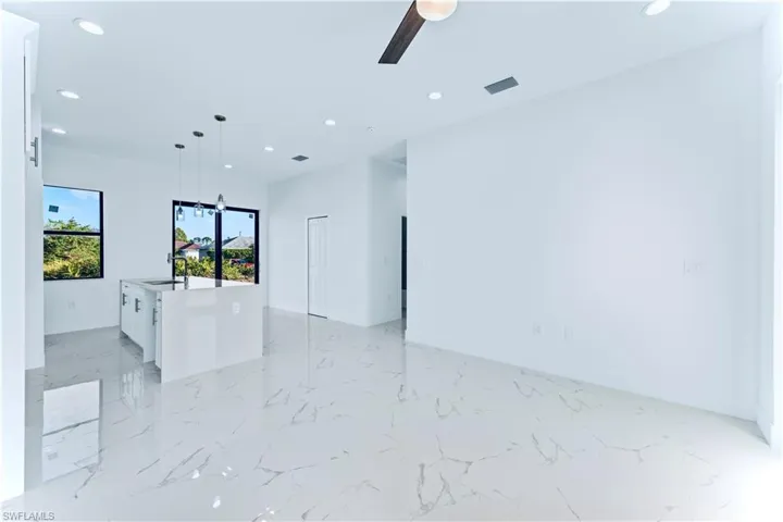 Unfurnished room with ceiling fan and sink