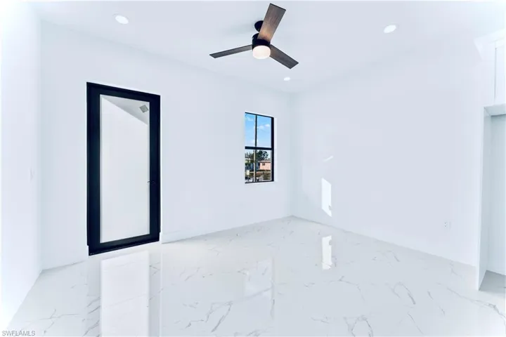 Unfurnished room featuring ceiling fan