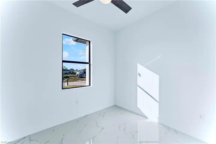 Empty room featuring ceiling fan