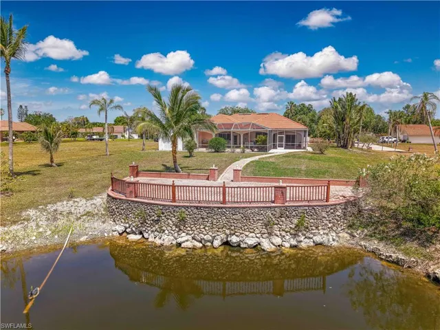 Back of property featuring a yard and a water view
