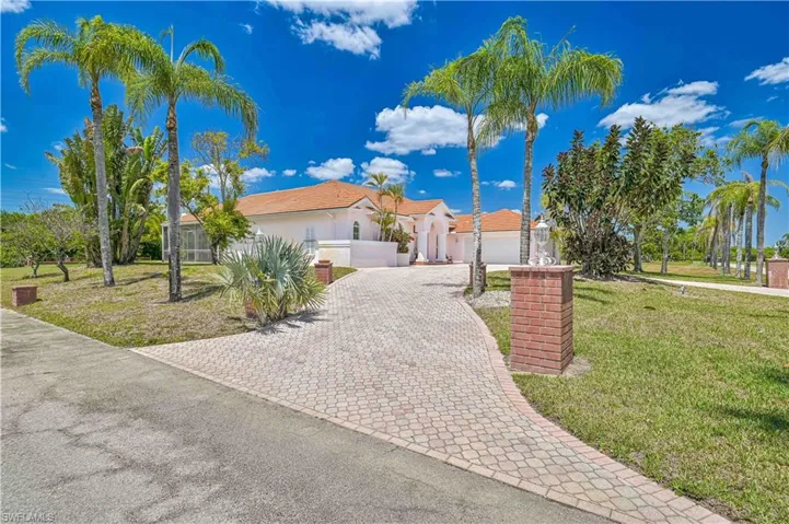 Mediterranean / spanish home with decorative driveway, a garage, fence private yard, and a front yard