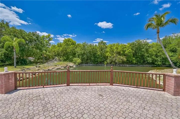 View of patio / terrace featuring fence and a water view