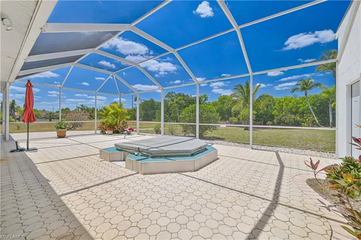 View of swimming pool featuring a lanai, a patio area, and a covered hot tub
